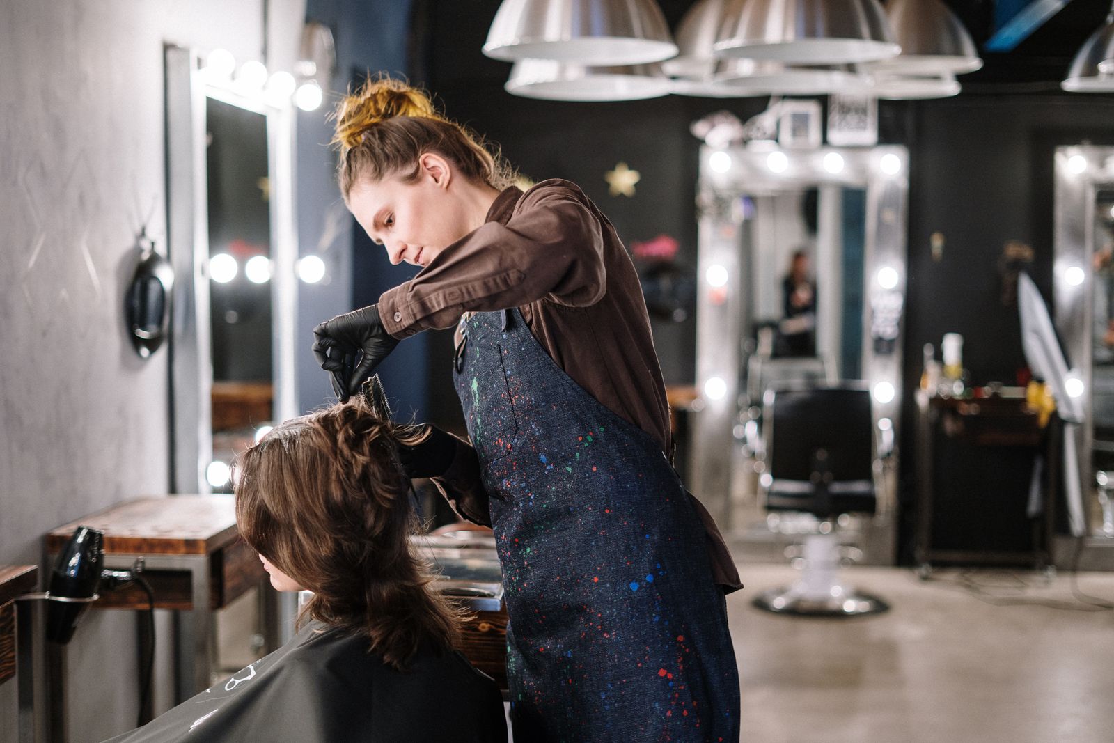 Imogen Park combing through a client's long red hair