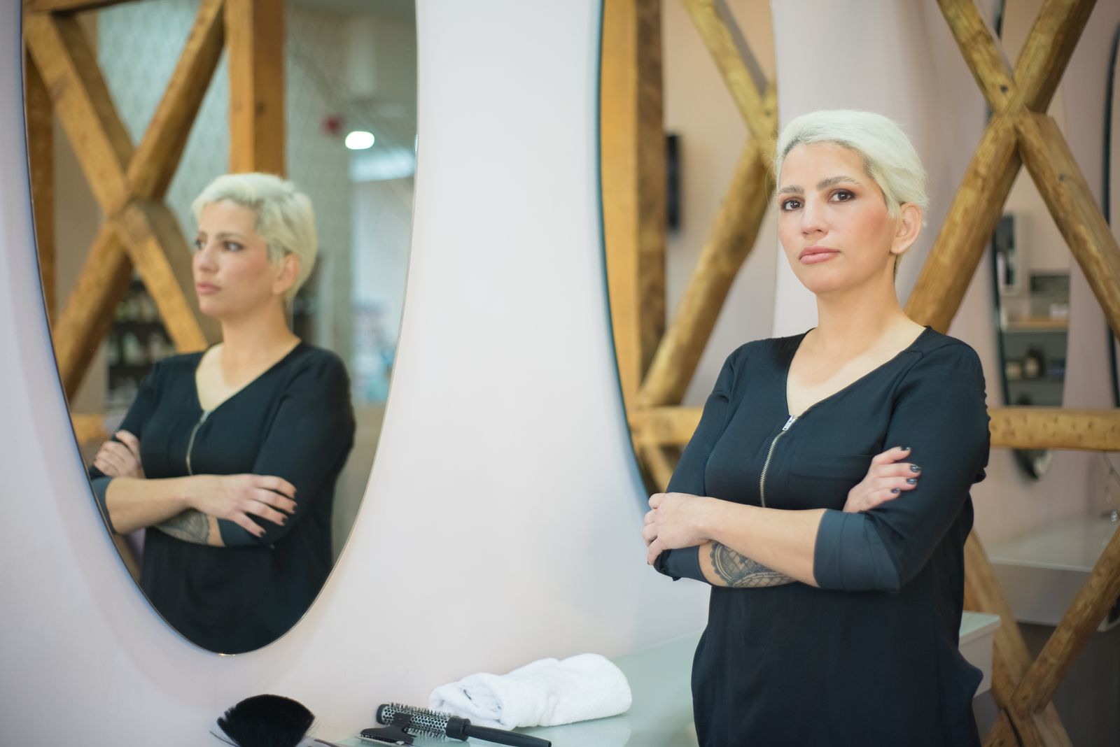 Celeste Moreau standing by the mirrors in the salon